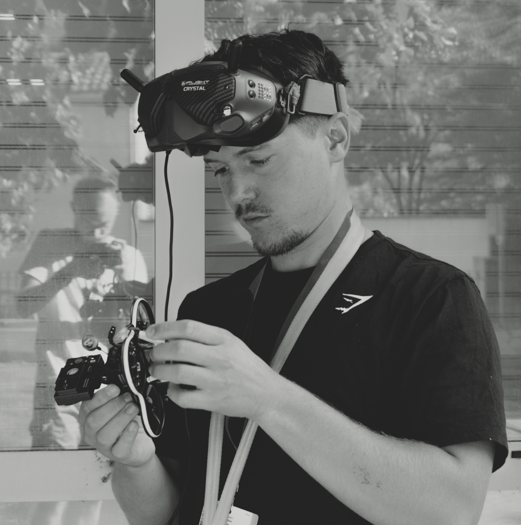 Un technicien règle sa caméra, en noir et blanc